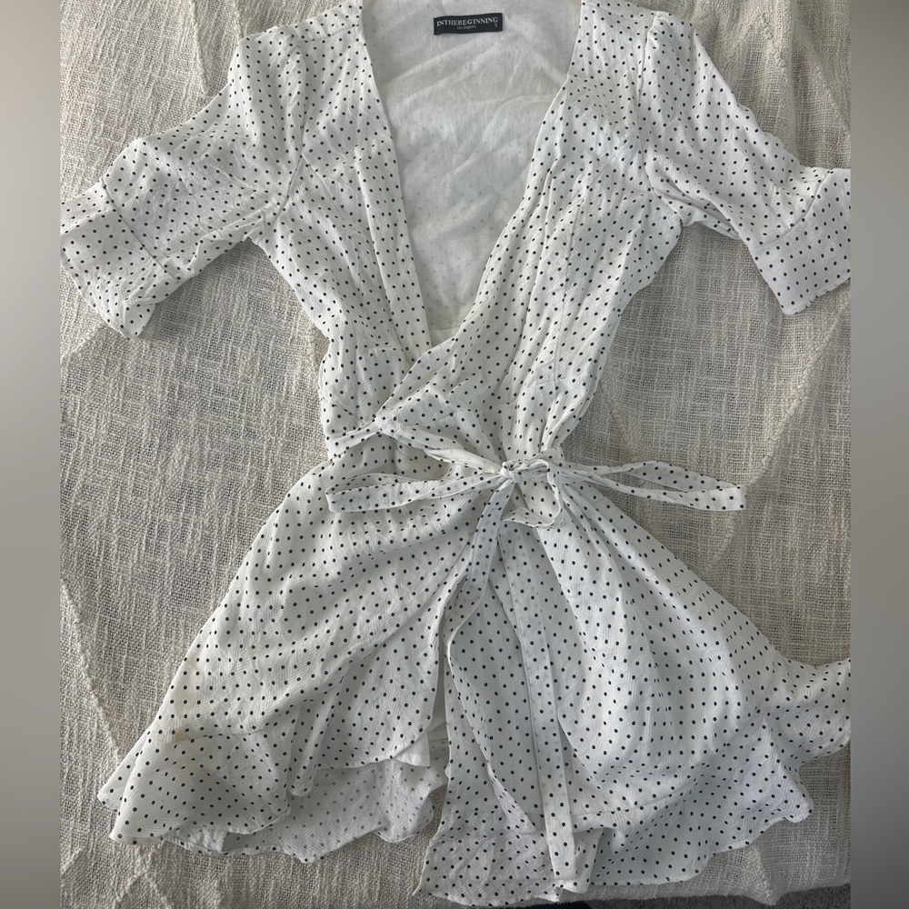 White and black polka dotted wrap mini dress